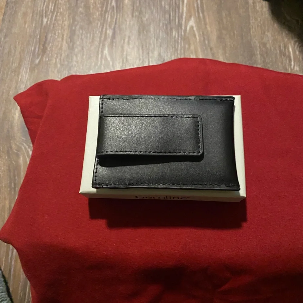 Man’s black leather money clip & card holder.